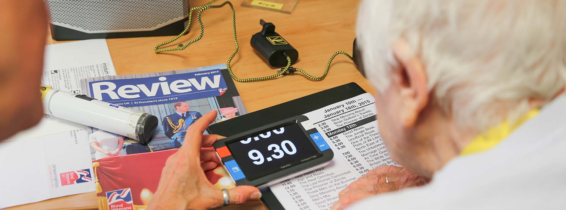 Photo of blind veteran Janet be trained to use a magnifier 
